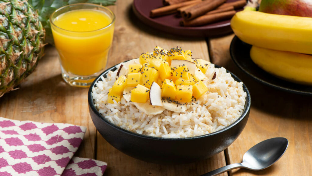 Breakfast bowl with jasmine rice, quinoa, mango and shredded coconut