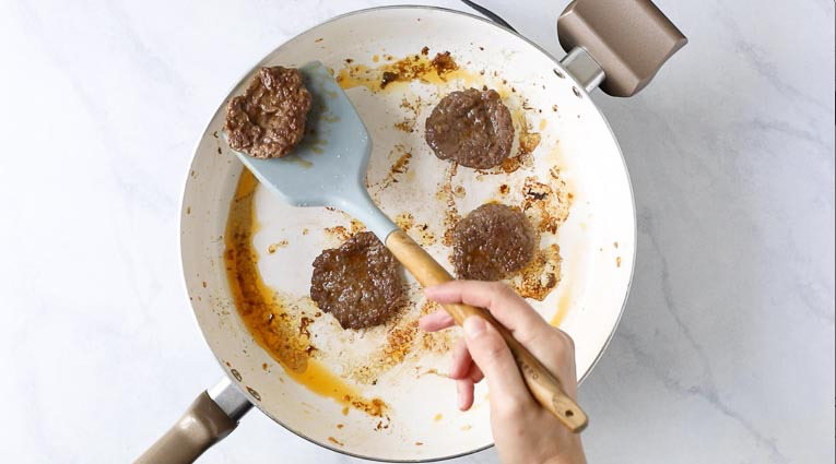 cooking burger patties in a pan