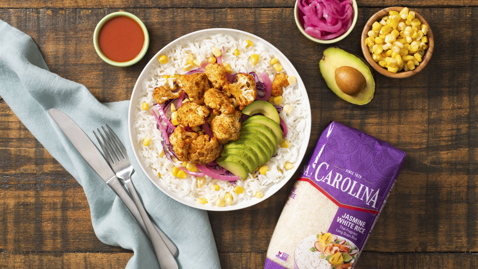 vegetarian-rice-bowl-with-buffalo-cauliflower-avocado-corn-and-pickled-onions