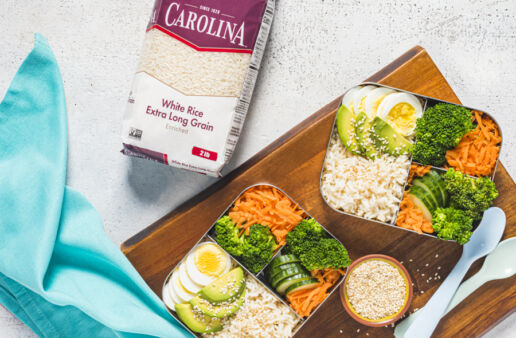 bento-box-with-white-rice-cooked-egg-avocado-cucumber-carrots-and-broccoli