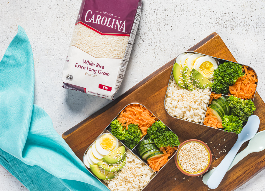 bento-box-with-white-rice-cooked-egg-avocado-cucumber-carrots-and-broccoli